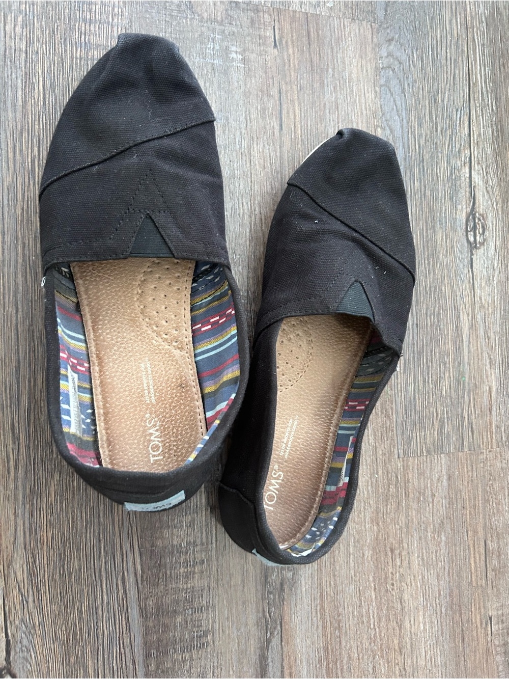 Toms Black Canvas Slip-Ons with Striped Interior